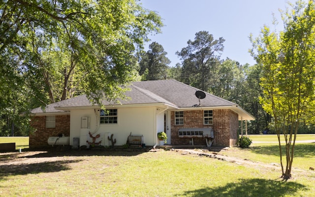 1867 Fm 2423, Grapeland, TX 75844 - view of front of house featuring a shingled roof, a front lawn, and brick siding