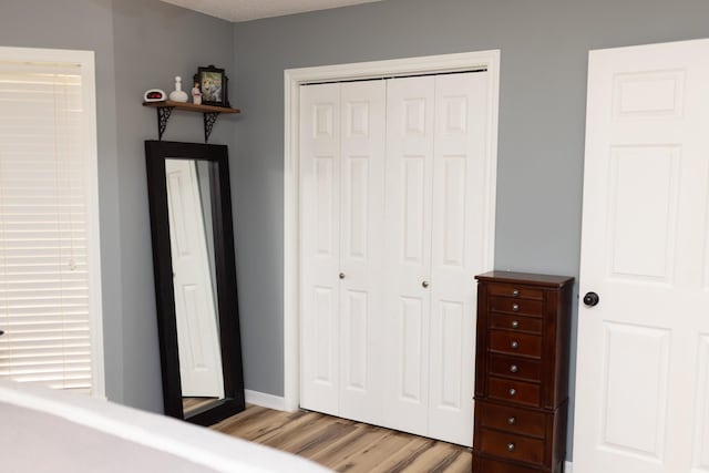 1867 Fm 2423, Grapeland, TX 75844 - bedroom with baseboards, light wood-type flooring, and a closet