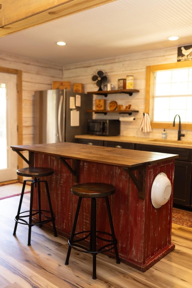 1867 Fm 2423, Grapeland, TX 75844 - bar with plenty of natural light, black microwave, a sink, and freestanding refrigerator