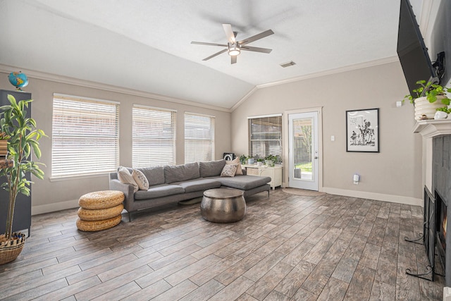 2884 Shallow Brook Ln, Dickinson, TX 77539 - living room featuring vaulted ceiling, a lit fireplace, a ceiling fan, baseboards, and dark wood-style flooring