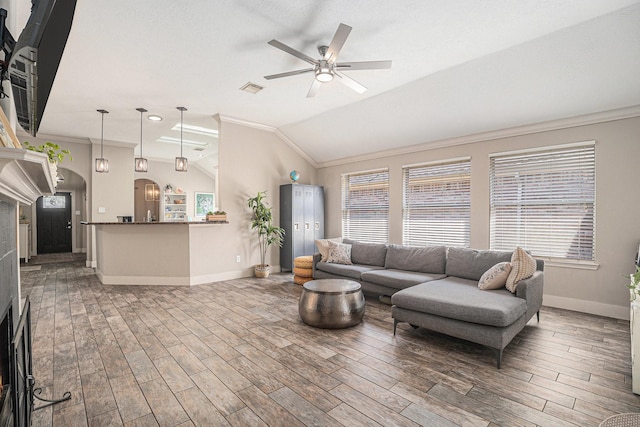 2884 Shallow Brook Ln, Dickinson, TX 77539 - living area featuring crown molding, baseboards, ceiling fan, wood finished floors, and healthy amount of natural light