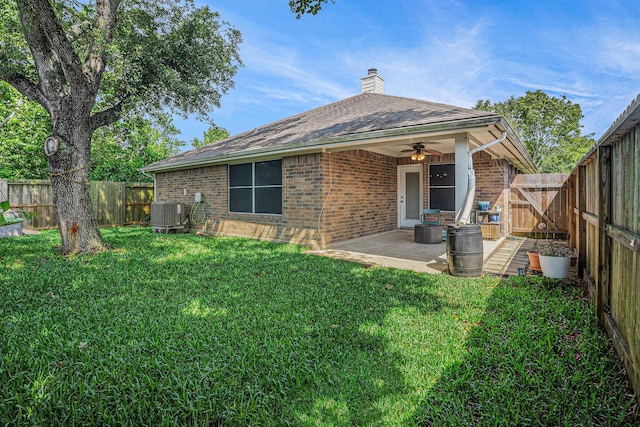 2884 Shallow Brook Ln, Dickinson, TX 77539 - rear view of house with brick siding, a ceiling fan, a chimney, and a patio