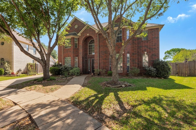 6919 S Gold River Cir, Missouri City, TX 77459 - traditional-style home featuring fence, brick siding, and a front yard