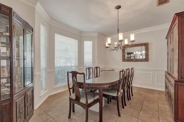 6919 S Gold River Cir, Missouri City, TX 77459 - dining space with crown molding, visible vents, an inviting chandelier, and a decorative wall