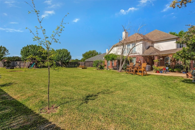 6919 S Gold River Cir, Missouri City, TX 77459 - view of yard with a fenced backyard, a patio area, and a playground