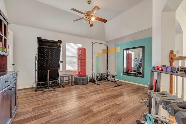 6919 S Gold River Cir, Missouri City, TX 77459 - exercise room with a ceiling fan, light wood-style floors, arched walkways, baseboards, and lofted ceiling
