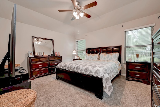 bedroom featuring lofted ceiling, carpet, and a ceiling fan