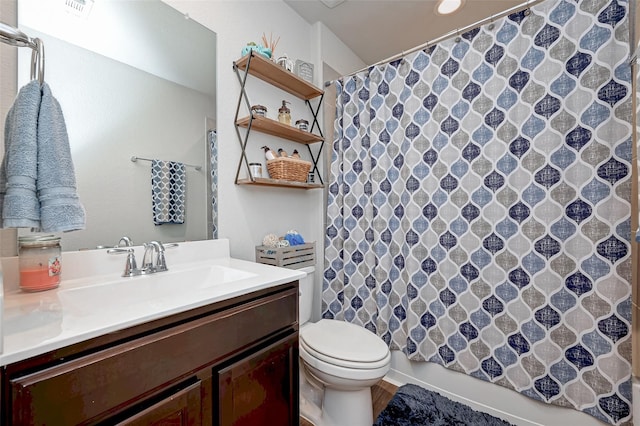 bathroom featuring vanity, toilet, visible vents, and curtained shower