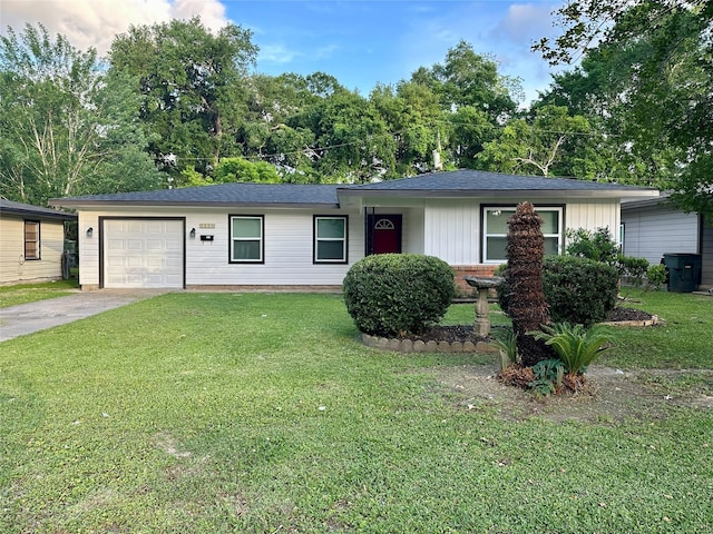 single story home with a shingled roof, driveway, a front yard, and a garage