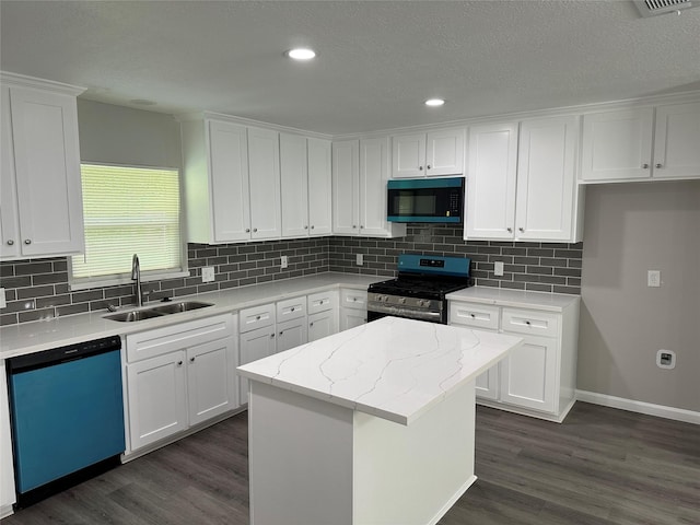 kitchen with a sink, black microwave, dishwasher, stainless steel gas stove, and dark wood-style floors