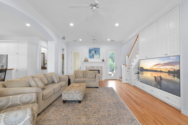 1207 N Shore Dr, Clear Lake Shores, TX 77565 - living area with ceiling fan, light wood-style floors, recessed lighting, ornamental molding, and stairway