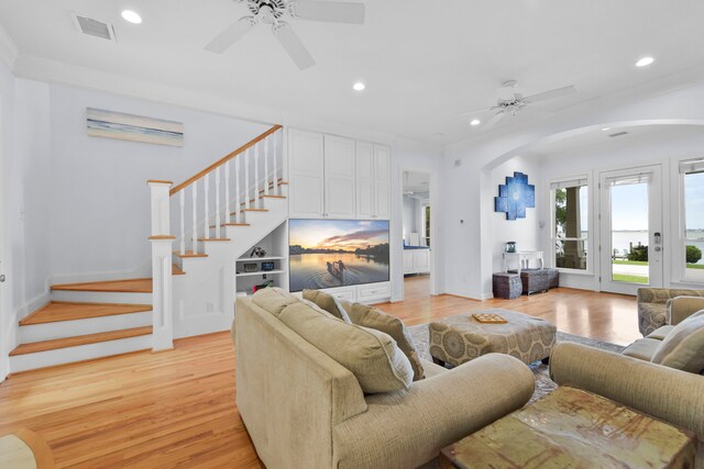 1207 N Shore Dr, Clear Lake Shores, TX 77565 - living area with a ceiling fan, arched walkways, light wood-style flooring, recessed lighting, and stairway