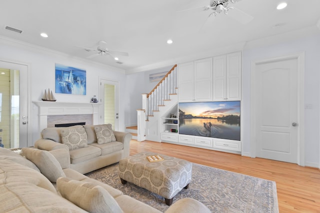living room featuring a ceiling fan, visible vents, recessed lighting, and stairs