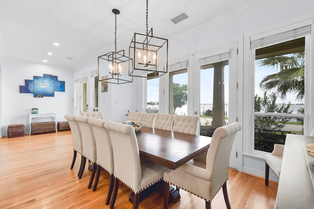 dining area with recessed lighting, visible vents, french doors, light wood-type flooring, and a notable chandelier