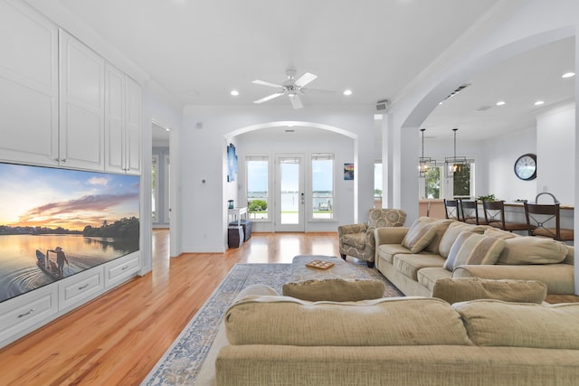 1207 N Shore Dr, Clear Lake Shores, TX 77565 - living area featuring arched walkways, light wood finished floors, recessed lighting, a ceiling fan, and crown molding
