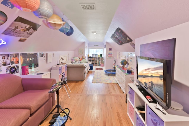 1207 N Shore Dr, Clear Lake Shores, TX 77565 - living room featuring light wood finished floors and lofted ceiling