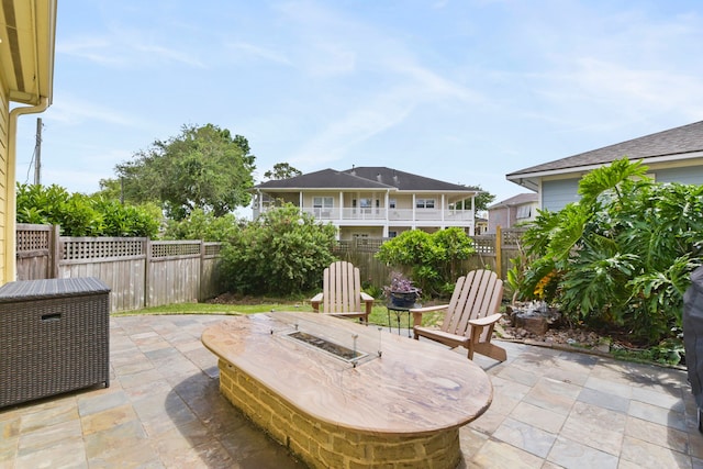 view of patio / terrace with a fenced backyard and a fire pit