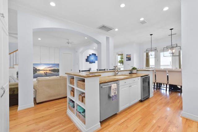 1207 N Shore Dr, Clear Lake Shores, TX 77565 - kitchen with dishwasher, a sink, wine cooler, arched walkways, and recessed lighting