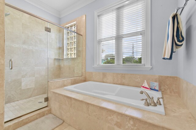 full bath featuring a bath, a shower stall, and crown molding