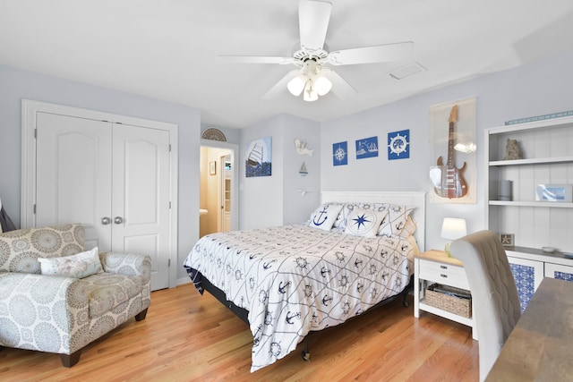 bedroom with wood finished floors, a closet, and ceiling fan