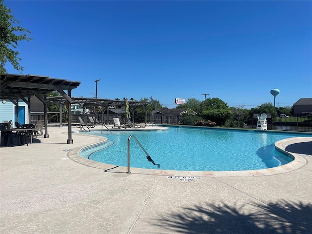 pool with a pergola, a patio, and fence