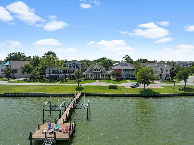 1207 N Shore Dr, Clear Lake Shores, TX 77565 - dock area featuring boat lift, a water view, a residential view, and a yard