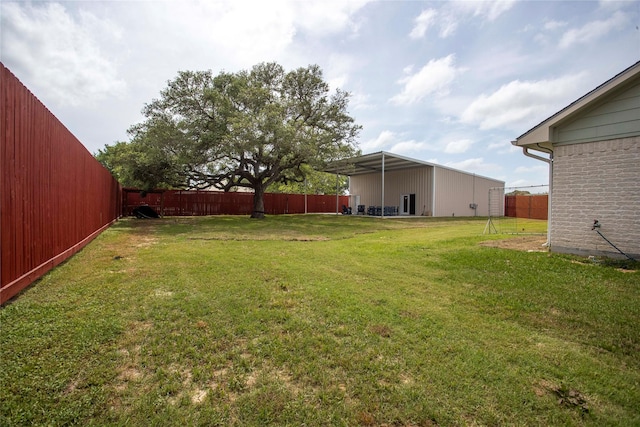 view of yard featuring fence and a pole building