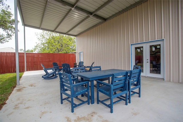 view of patio with fence, french doors, and outdoor dining space