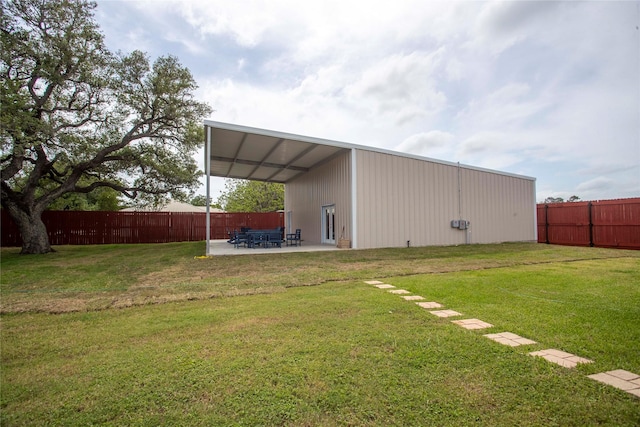 view of pole building featuring fence and a lawn