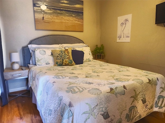 bedroom with wood finished floors