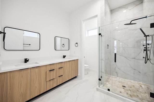 full bath with marble finish floor, double vanity, toilet, a marble finish shower, and a sink