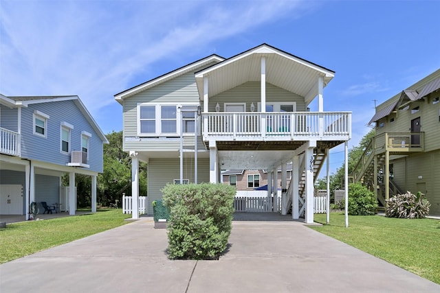 view of front facade with a front lawn, driveway, stairs, and a carport