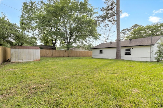 5 Skylark St, Dayton, TX 77535 - view of yard featuring a fenced backyard, a shed, and an outbuilding