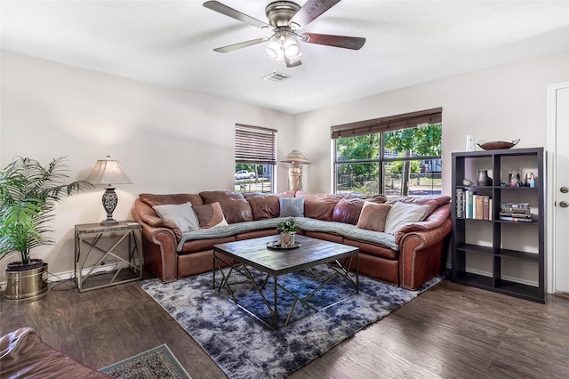living area featuring wood finished floors, a ceiling fan, and visible vents