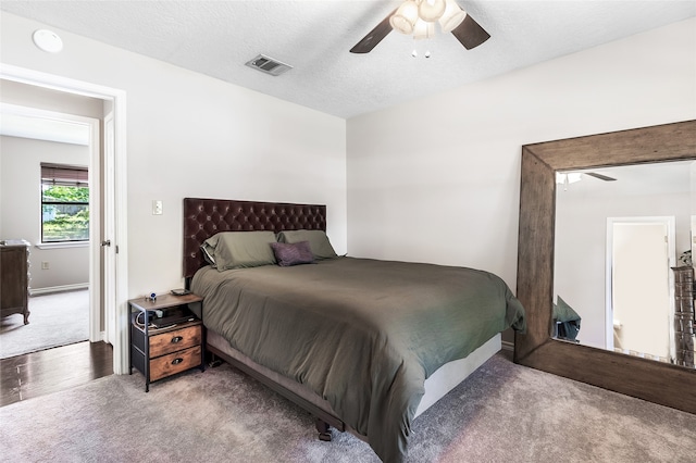 carpeted bedroom with baseboards, a ceiling fan, and visible vents
