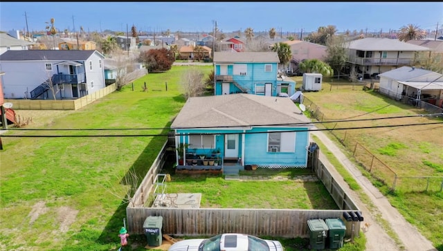back of house featuring a residential view and a fenced backyard