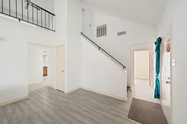 1823 Mandrill Ln, Houston, TX 77067 - entrance foyer featuring high vaulted ceiling, baseboards, wood finished floors, and visible vents
