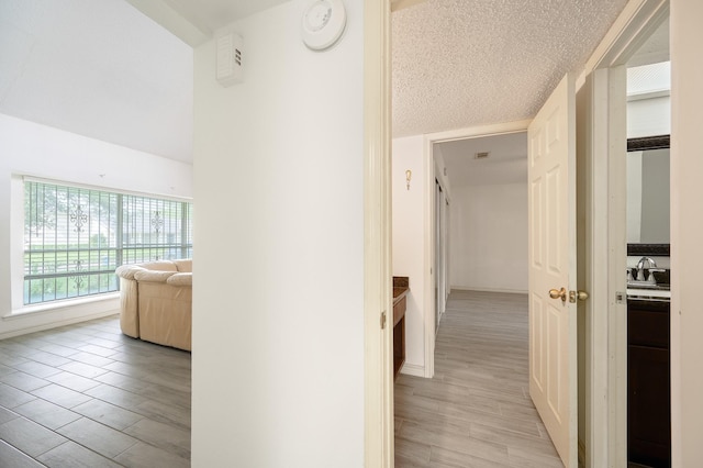 1823 Mandrill Ln, Houston, TX 77067 - hall with baseboards, light wood-type flooring, and a textured ceiling