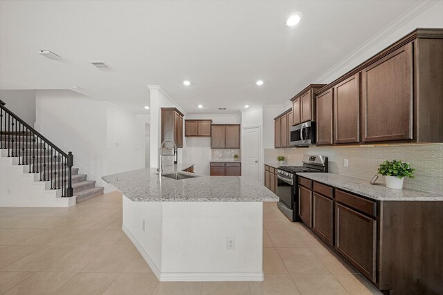 1706 Country Air Ln, Missouri City, TX 77459 - kitchen featuring stainless steel appliances, a sink, tasteful backsplash, visible vents, and light tile patterned floors