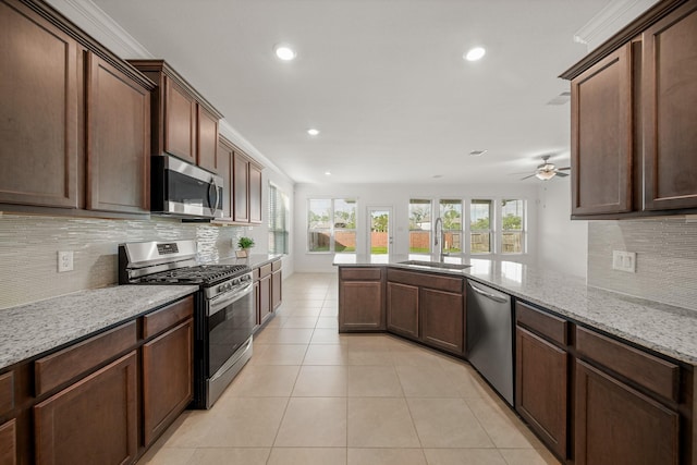 1706 Country Air Ln, Missouri City, TX 77459 - kitchen with stainless steel appliances, a sink, recessed lighting, decorative backsplash, and ceiling fan