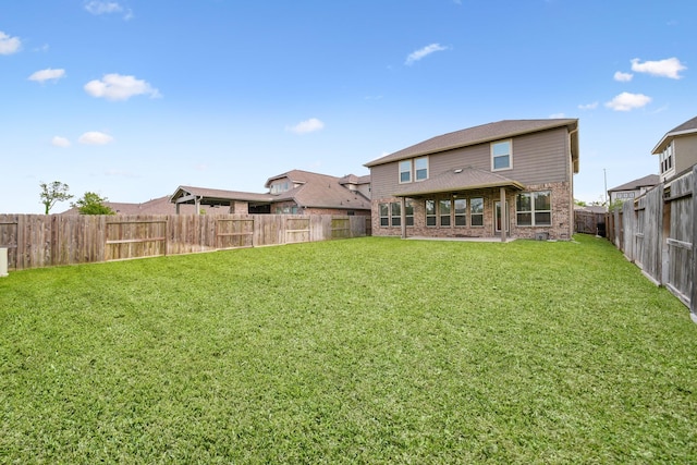 1706 Country Air Ln, Missouri City, TX 77459 - back of property with a lawn, brick siding, and a fenced backyard