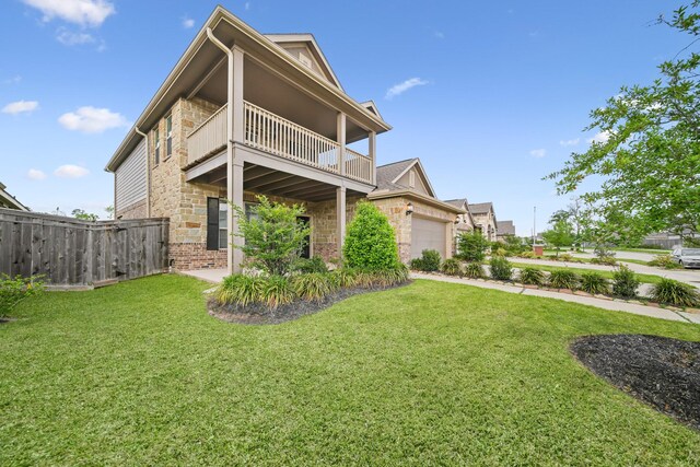 1706 Country Air Ln, Missouri City, TX 77459 - rear view of property with a balcony, an attached garage, fence, a yard, and brick siding