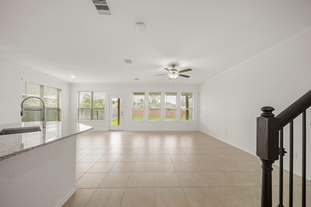 1706 Country Air Ln, Missouri City, TX 77459 - unfurnished living room with visible vents, a ceiling fan, a wealth of natural light, and a sink