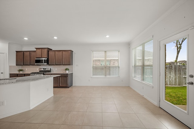 1706 Country Air Ln, Missouri City, TX 77459 - kitchen featuring backsplash, appliances with stainless steel finishes, light stone counters, and ornamental molding