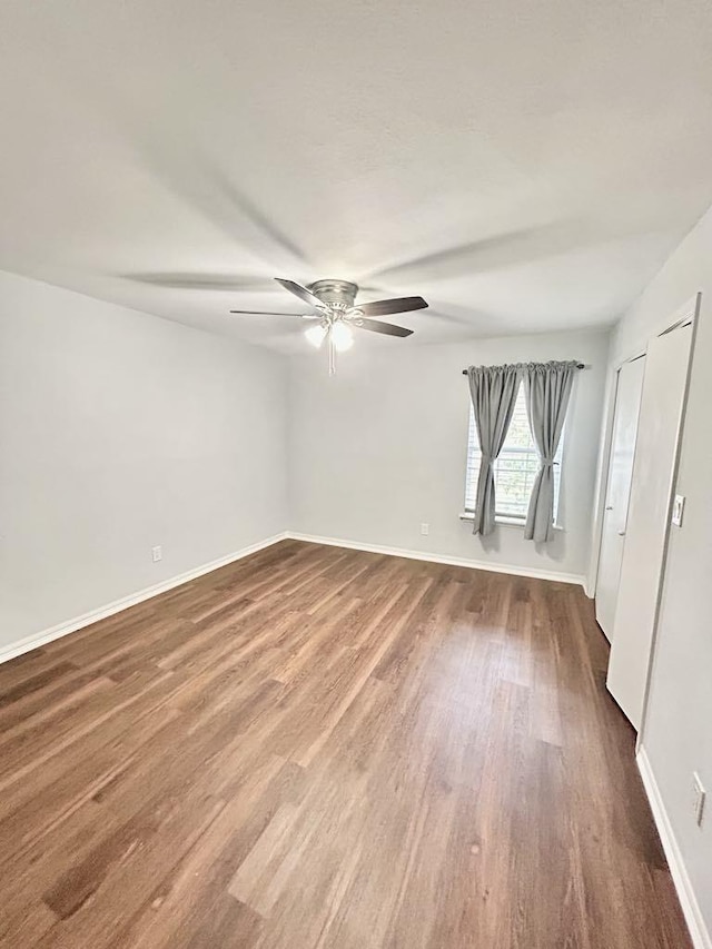 11115 Oakcenter Dr, Houston, TX 77072 - empty room featuring dark wood-style floors, a ceiling fan, and baseboards