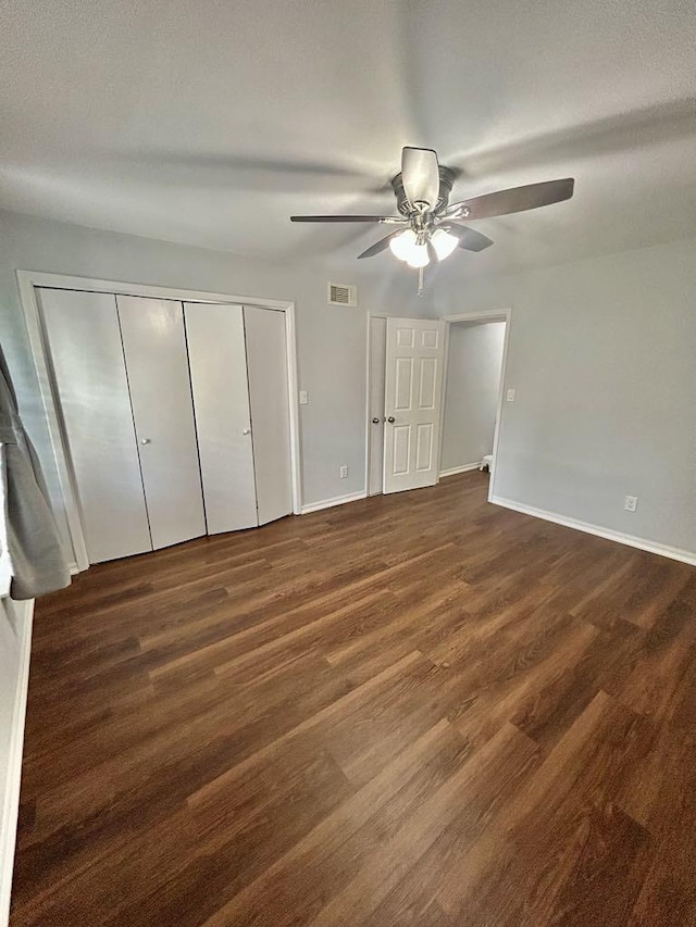 11115 Oakcenter Dr, Houston, TX 77072 - unfurnished bedroom featuring dark wood-style flooring, baseboards, and ceiling fan