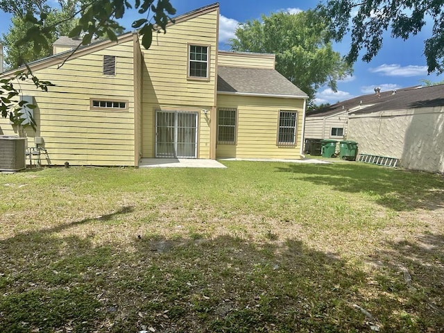 11115 Oakcenter Dr, Houston, TX 77072 - back of property featuring a yard, central AC unit, and a shingled roof