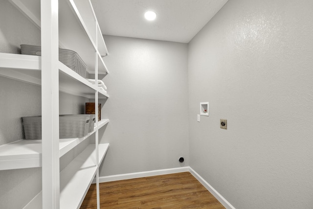 laundry room featuring baseboards, hookup for a washing machine, wood finished floors, electric dryer hookup, and laundry area