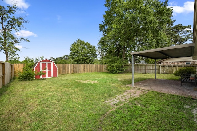 view of yard featuring a fenced backyard, a shed, an outbuilding, and a patio