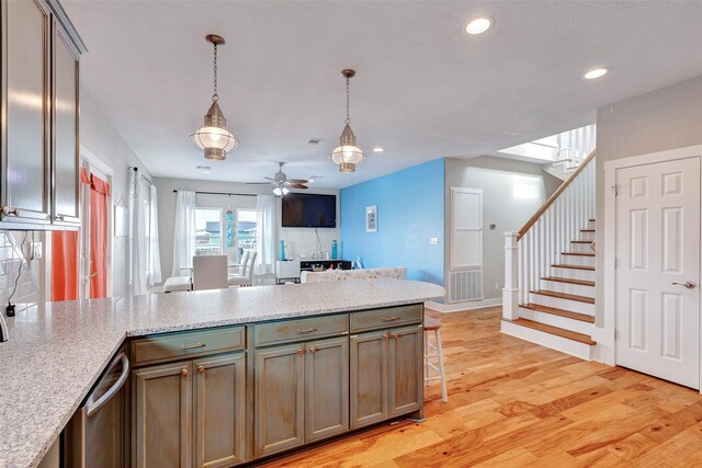 126 Driftwood, Freeport, TX 77541 - kitchen with a ceiling fan, dishwasher, a peninsula, decorative light fixtures, and light wood finished floors